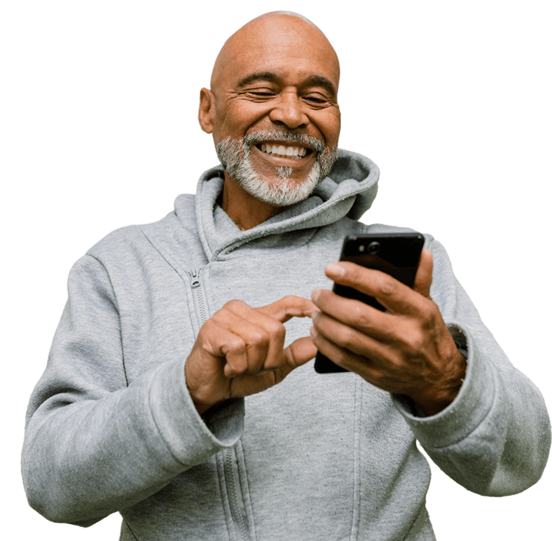 Smiling older man holding his phone